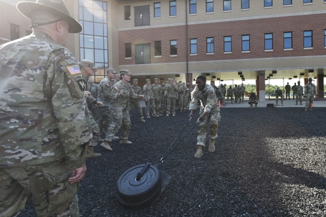 Pvt. Gabriy’el Fraser, an Army Horizontal Construction Engineer Advanced Individual Training student with Company A, 554th Engineer Battalion, drags a 90-pound sled while Soldiers in his unit cheer him on Aug. 25 during the company’s weekly...