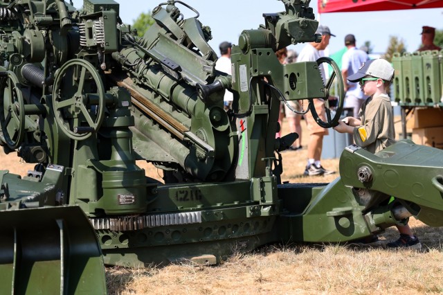 A U.S.A.G. Fort Devens 105th Anniversary celebration attendee touches one of the static displays