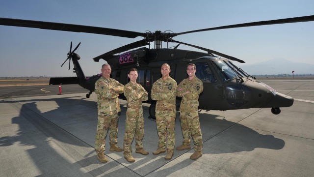 HH-60 MEDEVAC Helicopter Crew in front of their aircraft Sgt. 1st Class Mark Carter, 1st Lt. Conner Breedlove, Chief Warrant Officer Corey Wadsworth, and Spc. Blakely Stone at Medford Airport, Ore. Sept. 2, 2022. Oregon National Guard members support the Rum Creek fire fighting efforts with traffic control, road closure points, and medical air evacuation helicopter assets.