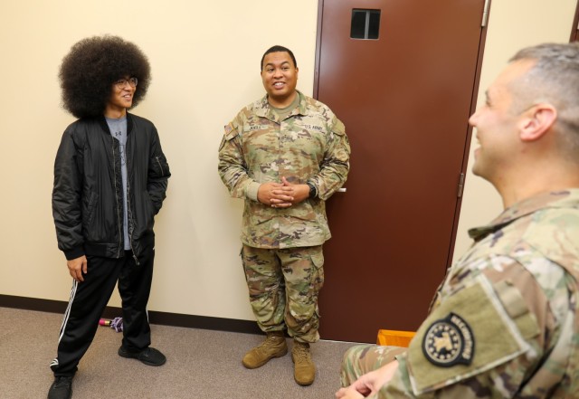 Chief Warrant Officer 2 Keith Joell, center, who is assigned to U.S. Army Japan, and his son, Ke’Shaun, speak with his recruiter, Sgt. 1st Class Jason Blowers, at the Camp Zama recruiting office in Japan, Sept. 2, 2022. Joell administered the oath of enlistment to Ke’Shaun during a ceremony at the office in late July.