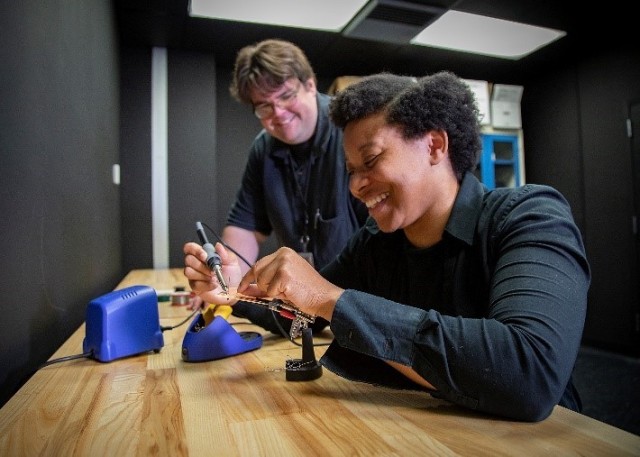  Onye Andrus practices soldering circuits onto a breadboard with her USAARL mentor, Dr. Kevin O’Brien, in their laboratory at the U.S. Army Aeromedical Research Laboratory.
