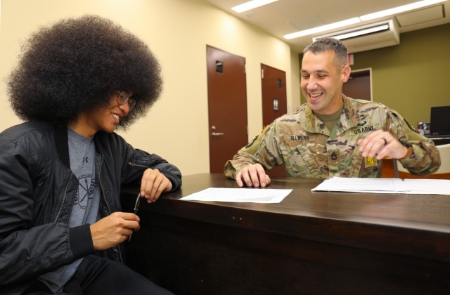 Ke’Shaun Joell, left, signs some paperwork for his recruiter, Sgt. 1st Class Jason Blowers, inside the Camp Zama recruiting office in Japan, Sept. 2, 2022. Ke’Shaun plans to ship off for basic training in early October to become a financial...