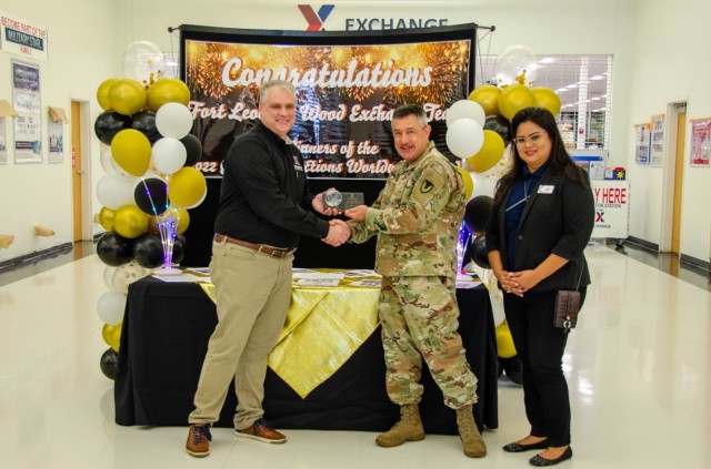 Fort Leonard Wood Army and Air Force Exchange Service General Manager Donald Cantwell and Main Exchange Store Manager Stacy Firemoon accept the 2022 Global Connections Worldwide Award from U.S. Army Garrison Fort Leonard Wood Commander Col....