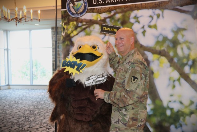 U.S. Army Communications-Electronics Command Sgt. Maj. Michael Conaty poses for a photobooth picture with APG mascot, Baldwin, at a C5ISR technology exposition at Top of the Bay Aug. 22, 2022.
