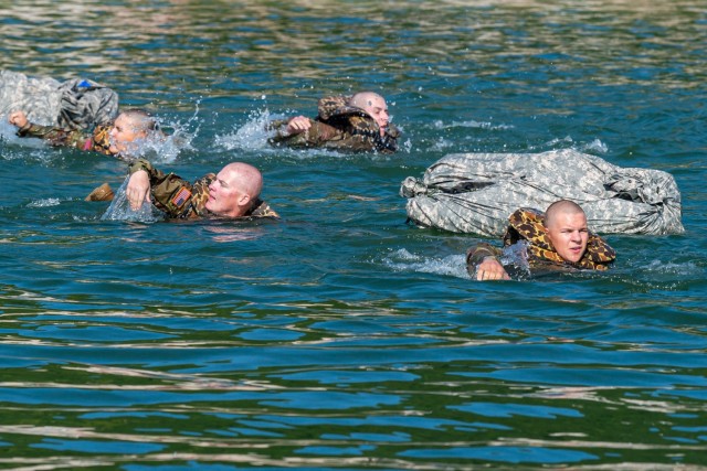 Combat engineer and bridge crewman trainees with Company B, 35th Engineer Battalion, cross the lake at Training Area 250 Wednesday with poncho rafts as an add-on to the field-training exercise portion of their instruction. Building poncho rafts is not part of the required program of instruction for these trainees, but was conducted to show some of the additional knowledge available in follow-on schools Soldiers can attend throughout their career, such as the Sapper Leader Course. 