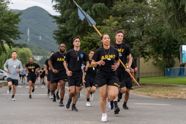 Soldiers reach the final stretch during a 2-mile run at Camp Walker, Republic of Korea, September 12, 2022. The run was in memory of firefighters killed by the 9/11 terrorist attacks. Runners wore nametags of the individual firefighters lost to honor their sacrifice.