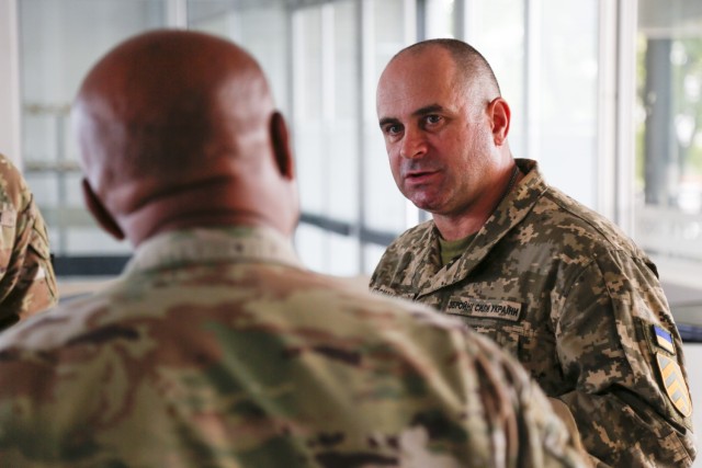 Ukrainian Chief Master Sgt. Oleksandr Kosynskyi, the command senior enlisted leader of the Armed Forces of Ukraine, talks with Senior Enlisted Advisor Tony Whitehead, the SEA to the chief, National Guard Bureau, during the Supreme Headquarters...