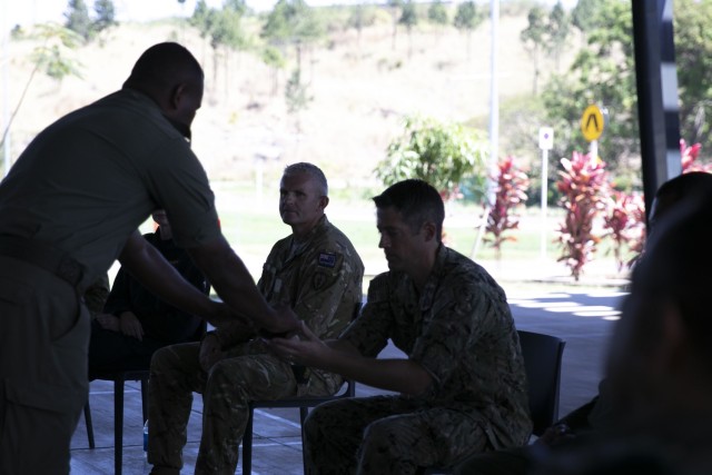 U.S. Navy Cmdr. Victor Lange, Senior Defense Official/Defense Attaché, US Embassy, SUVA, Fiji, receives a bowl of Kava during the Kava Ceremony to symbolize the start of Exercise Cartwheel 2022 at Black Rock Camp, Fiji. Military-to-military training with RFMF forces increases readiness and the ability to respond quickly; working together effectively in a crisis, such as natural disasters, improves response capabilities to situations which threaten public health and safety. (U.S. Army photo by Sgt. 1st Class Andrew Guffey 343rd Mobile Public Affairs Detachment)