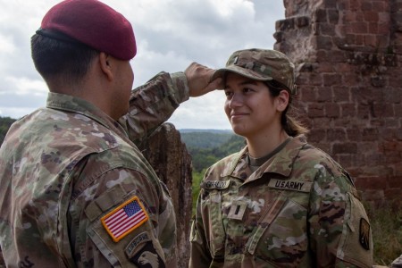 Chief Warrant Officer 4 Andres Giraldo, a targeting officer assigned to the XVIII Airborne Corps, pins the patrol cap of 1st Lt. Chesnee Giraldo, a quartermaster officer assigned to the 55th Quartermaster Field Feeding Company, 16th Special Troops Battalion, 16th Sustainment Brigade. Andres’ deployment to near where Chesnee is stationed allowed him to attend her promotion ceremony, after missing other big moments in her life due to operational requirements.