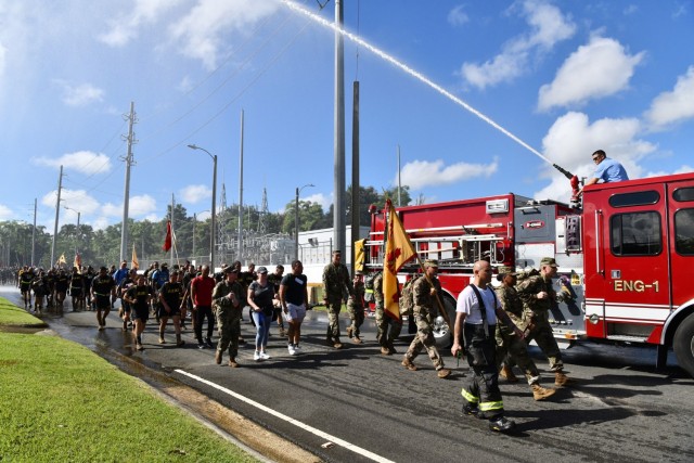Fort Buchanan Fire Department provided two Water Salutes, from two of their firefighting rigs spraying arcs of water over the approximate 1,500 Soldiers, Service Members, family and civilians participating in the 9/11 ruck march as a sign of...