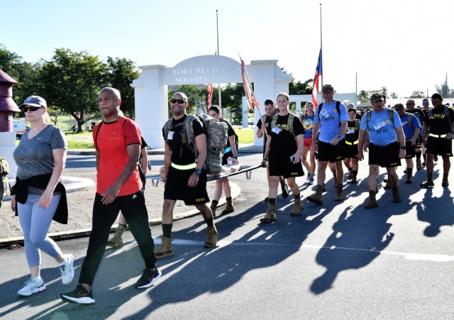 (L) Fort Buchanan Garrison Deputy to the Commander, Yvette L. Castro, civilians, Service members and  approximtely 1,500 Soldiers from the 166th RSG Brigade and family members departing from the installation’s Soldier Plaza participated in the...