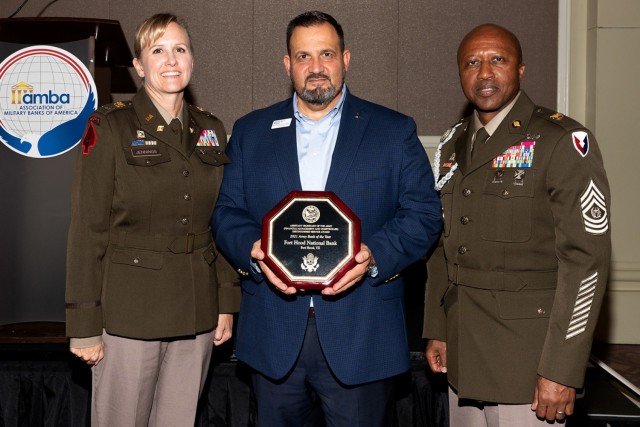 Col. Paige M. Jennings, U.S. Army Financial Management Command commander, and Command Sgt. Maj. Kenneth F. Law, USAFMCOM senior enlisted advisor, right, present Fernando Fernandez, Fort Hood National Bank vice president of military banking, with the Army Distinguished Bank Service Award in Washington, D.C., Aug. 30, 2022. USAFMCOM presented the award on behalf of the Office of the Assistant Secretary of the Army for Financial Management and Comptroller to recognize and strengthen the critical partnership between the Army and civilian financial institutions serving Soldiers and their families. (Photo courtesy of Maj. Jose Rivera)