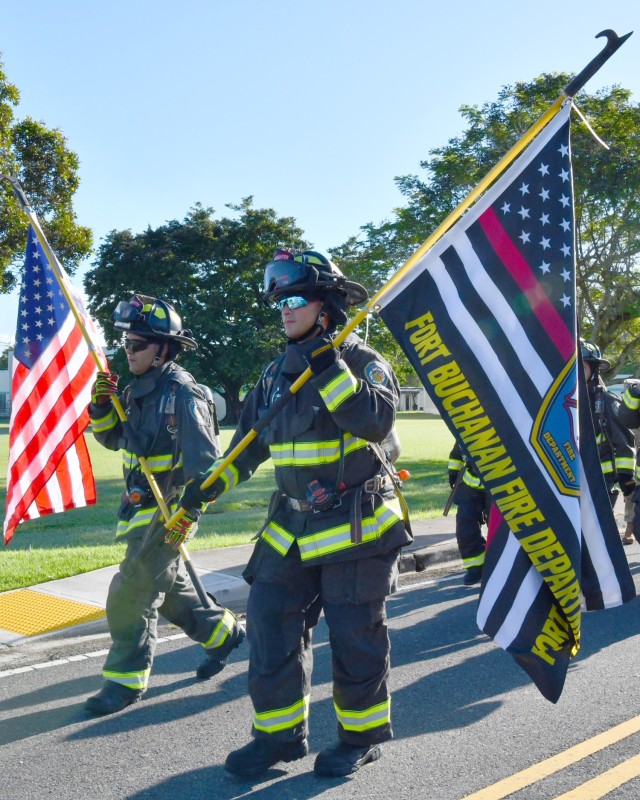 Fort Buchanan Firefighters, carrying the US flag, Emilio A. Torres and the Fort Buchanan Fire Department 9/11 flag Wilfred Rivera, marched in full gear in tribute to the fallen heroes of 9/11.