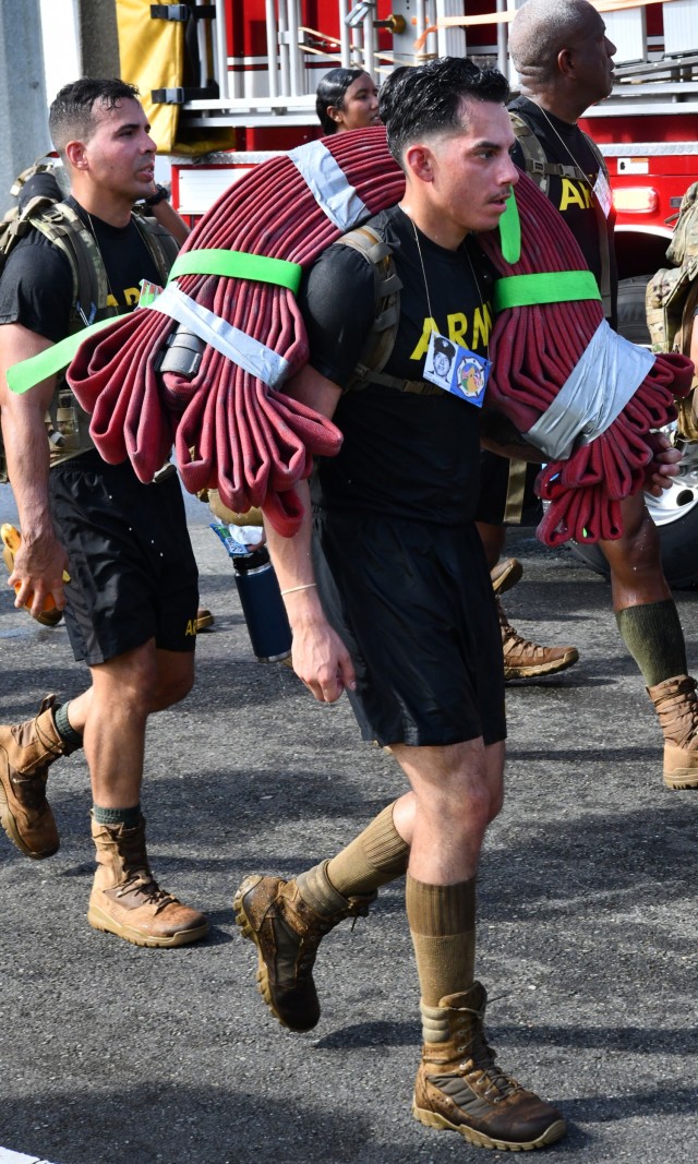Reenacting the sacrifices of first responders and in tribute to those heroes of 9/11 this Soldier from the 166th RSG Brigade carried, in addition to his rucksack, a hose pack during the ruck mach.