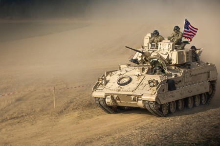 U.S. Soldiers aboard an M2A3 Bradley Fighting Vehicle lead a parade as part of the Tanks in Mons festivities held at Estinnes, Belgium, Aug. 27, 2022. Tanks in Mons, an annual event in its 21st year, brings people together to commemorate the Liberation of Belgium and the historic Battle of the Mons Pocket.