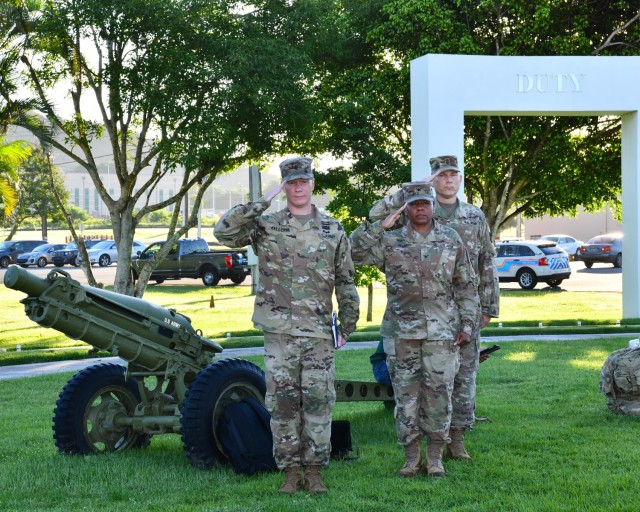 Garrison Command Chaplain Maj. David S. Keller, Garrison Commander Col. Tomika M. Seaberry and Garrison Command Sgt. Maj. Roderick W. Hendricks render honors, saluting the United States Flag during the opening of the 9/11 tribute and ceremony.