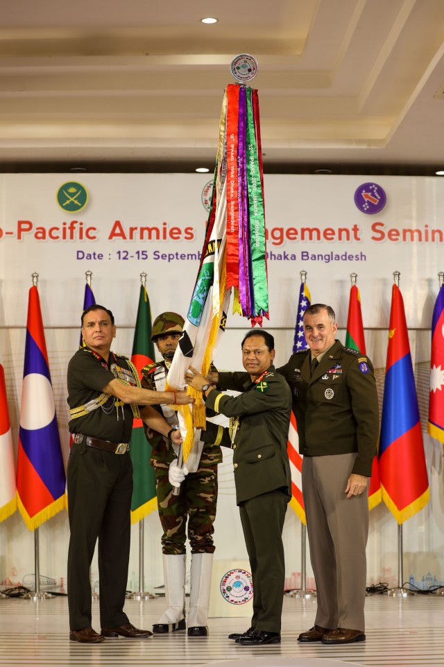 USARPAC Commanding General Charles A. Flynn and Bangladesh Chief of Army Gen. SM Shafiuddin Ahmed pass the conference flag to members of the Indian Army, the host of next year&#39;s IPAMS conference.