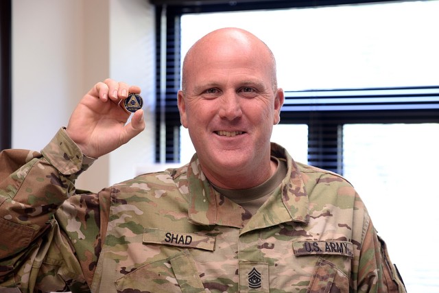 Command Sgt. Maj. Justin Shad, 15th Military Police Brigade, shows his 24-hour chip from Alcoholics Anonymous, which serves as a reminder that sobriety is counted 24 hours at a time. He encourages others to seek resources for alcoholism and addiction.