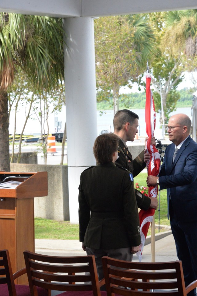 Incoming New Orleans District commander Col. Cullen Jones passes the Corps colors to New Orleans District Deputy Engineer Mark Wingate during the district&#39;s change of command ceremony on Sept. 16, 2022.