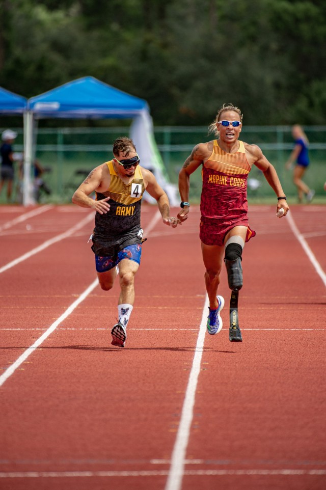 Retired U.S. Army Staff Sgt. Michael Murphy, left, is guided by U.S. Marine Sgt. Peter Keating while competing in a track event during the 2022 Department of Defense Warrior Games at the ESPN Wide World of Sports Complex in Orlando, Florida, Aug. 25, 2022. Hosted by the U.S. Army, service members and veterans from across the DoD compete in adaptive sports alongside armed forces competitors from Canada and Ukraine. (U.S. Army photo by Sgt. Henry Villarama)