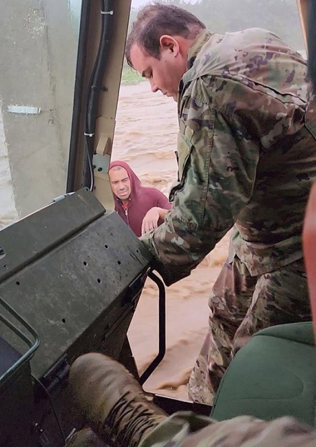 Members of the Puerto Rico National Guard, 125th Military Police Battalion, rescue a man who had apparently gone out to try to find gasoline and was caught in a flash flood caused by Hurricane Fiona in Ponce, near Mercedita Airport in southern Puerto Rico. The hurricane knocked out power to the entire island.
