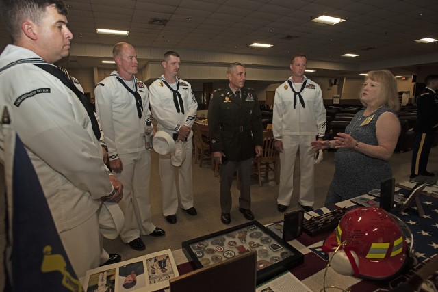 Teresa Cleaver, mother of Staff Sgt. John Cleaver, who passed away in 2009, speaks with Col. Sean Crockett, commandant of the U.S. Army Chemical, Biological, Radiological and Nuclear School (center), and Sailors from the Center for Seabees and...