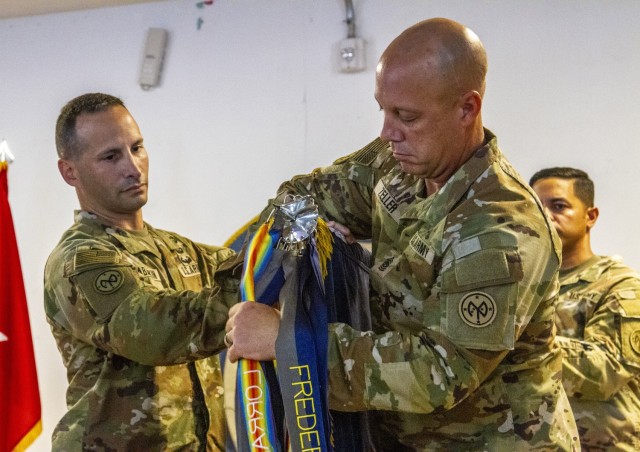 U.S. Army Lt. Col. Shawn Tabankin, the commander of 1st Battalion, 69th Infantry Regiment, and Command Sgt. Maj. Jason Zeller, the 1st Battalion, 69th Infantry Regiment, senior enlisted leader, unfurl the unit’s colors during a...