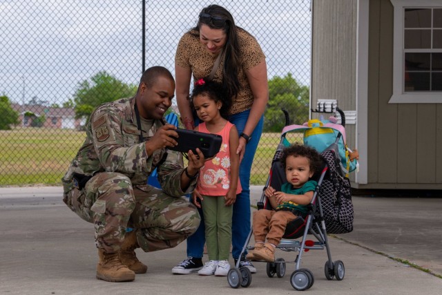U.S. Air Force Tech. Sgt. Billy Lofton, 325th Security Forces Squadron, noncommissioned officer in charge of plans, shows his family how to operate an unmanned ground vehicle at Tyndall Air Force Base, Florida, April 29, 2022. Lofton’s family participated in the family carnival event celebrating the Month of the Military Child.