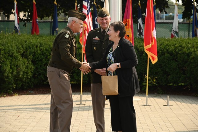 Col. Steven Carozza, U.S. Army Tank-automotive and Armaments Command’s chief of staff, presents Lana Henderson a gift from the TACOM headquarters office staff as Maj. Gen. Darren Werner, TACOM commanding general, looks on during a Retirement,...