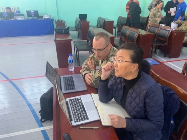 A US Army soldier from 8th Forward Resuscitative Surgical Detachment
fine-tunes the English to Mongolian translation for the table top exercise
with a translator. (Courtesy photo by U.S. Army soldier)
