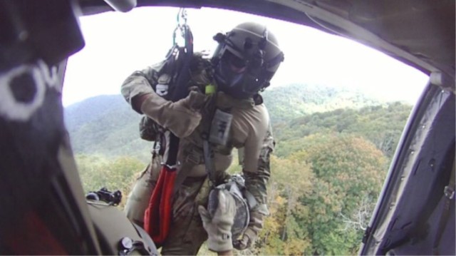 Sgt. 1st Class Giovanni DeZuani, a flight paramedic, is lowered from a UH-60 Black Hawk near Derrick Knob Shelter to rescue a hiker in distress along the Appalachian Trail near the Tennessee-North Carolina border Sept. 20, 2022. The flight crew from the Tennessee National Guard conducted the emergency air evacuation mission after a hiker reported chest pains. (Photo by Capt. Kealy Moriarty)
