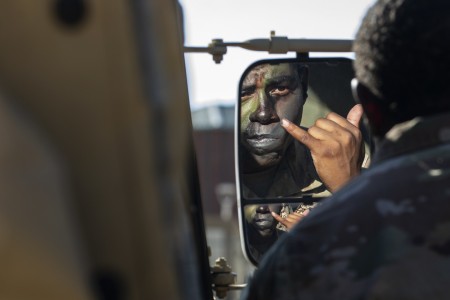 Spc. Brandon Charles Brown, an infantryman assigned to 4th Battalion, 9th Infantry Regiment,1st Stryker Brigade Combat Team, 4th Infantry Division, applies camouflage paint onto his face during the first morning of Command Post Exercise II (CPX II), Aug. 19, 2022, at the Mission Training Center, Fort Carson, Colorado. CPX II was a scenario-based exercise designed to prepare the division staff for an upcoming large-scale field operation later this year.