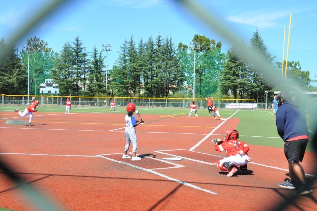 A player on the Daegu CYS baseball team receives a pitch from a player on a Korean team during a tournament at Camp Walker, Republic of Korea. The tournament is part of a cultural exchange experience organized by the Daegu CYS staff.  