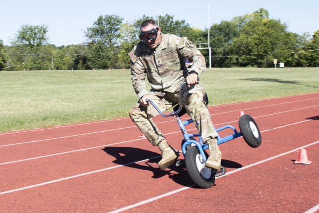 Command Sgt. Maj. Russell O’Donnell, from the 2nd Battalion, 10th Infantry Regiment, fails in his attempt to successfully navigate a tricycle driving course while wearing drunk goggles during a suicide prevention awareness and education event Tuesday on Gerlach Field, in line with Suicide Prevention Awareness Month. Alcohol abuse is often a key factor in suicide.