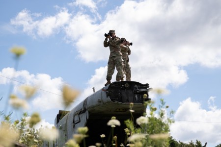 U.S. Army Reserve Sgt. Mikayla Fritz, a public affairs mass communication specialist with the 358th Public Affairs Detachment, and Sgt. 1st Class Debrah Sanders, the non-commissioned officer in charge of the 366th Mobile Public Affairs Detachment, stand on plane wreckage to take a photo at Muscatatuck Urban Training Center, Muscatatuck, Indiana, Aug. 16, 2022. The MUTC offers real life training in urban and rural environments with different scenarios.