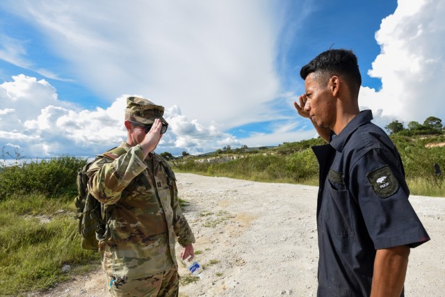 Capt. Madison Bips, a member of the Georgia National Guard's 1st Battalion of the 54th Security Force Assistance Brigade, returns a salute from a member of the Honduran Armed Forces Sept. 8, 2022, near Tegucigalpa, Honduras. The 54th SFAB was...