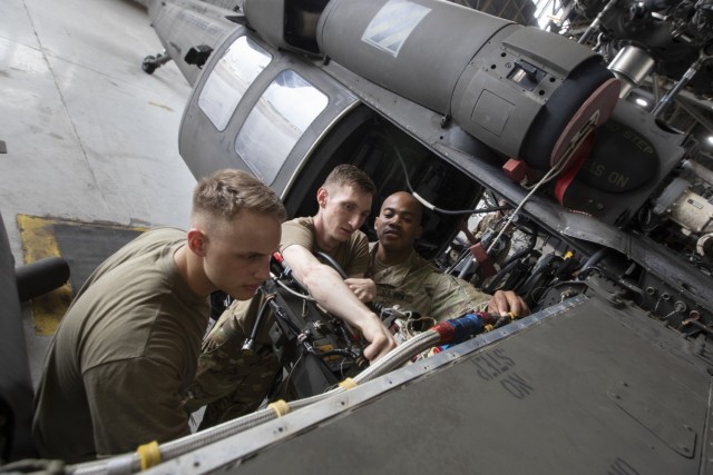 UH-60 Black Hawk helicopter repairers assigned to 2nd Battalion, 3rd General Support Aviation Battalion, 3rd Combat Aviation Brigade, 3rd Infantry Division, conduct maintenance on an aircraft at Hunter Army Airfield, Georgia, July 20. Routine maintenance and inspections are done on aircraft to maintain the brigade's readiness. (U.S. Army photo by Sgt. Andrew McNeil / 3rd Combat Aviation Brigade, 3rd Infantry Division)