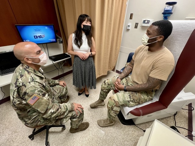 Col. Anthony Noya, chief of the patient centered medical home at Bayne-Jones Army Community Hospital conducts a warm hand-off with Anna Pinkelman, licensed clinical social worker and behavioral health consultant within the department, during an appointment at the Joint Readiness Training Center and Fort Polk, Louisiana. The primary care behavioral health program is a team-based approach to manage behavioral health problems and influence health conditions from a biopsychosocial perspective.