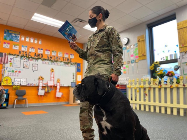 Sgt. Maj. Viridiana Lavalle, the Army Military Working Dog program manager and the Army&#39;s senior most MWD handler reads a book on military working dogs to elementary school students at Fort Sill, Okla, on April 16, 2021. Lavalle is the first woman to hold the position. 