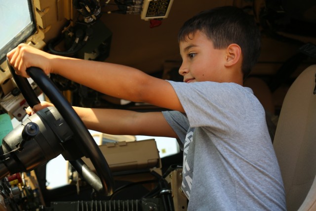 Fair visitor Dante Campos practices his driving skills in a Humvee with crew served weapons at the El Paso Police Department Community Fair at Joey Barraza and Vino Memorial Park, Sept. 10. The event was an opportunity for Fort Bliss Soldiers to connect with the local El Paso community, and showcase various types of combat equipment used by the Army.