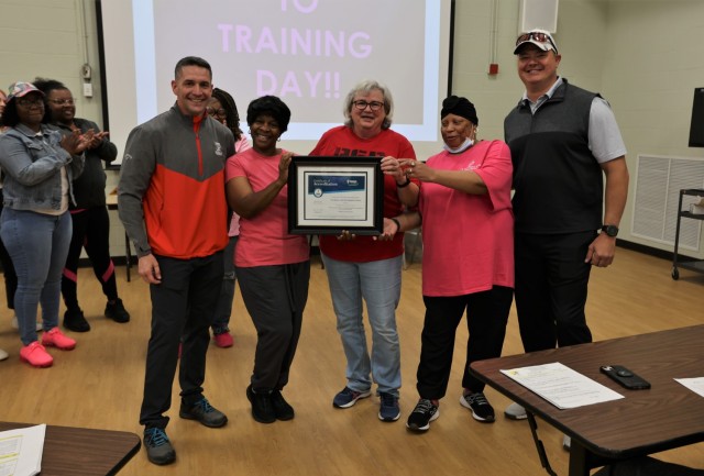 Fort Knox Garrison Commander Col. Lance O’Bryan and Command Sgt. Maj. William Fogle present members of the Child Development Center team with the National Association for the Education of Young Children reaccreditation certificate on Oct. 7, 2022.