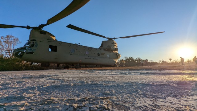 Civilian search and rescue personnel board a CH-47F Chinook helicopter operated by New York Army National Guard Soldiers assigned to B Company, 3rd Battalion, 126th Aviation Regiment, Oct. 2, 2022. They were flown to Sanibel Island, Florida, after...