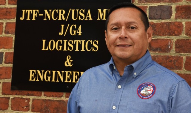 Jose H. Ramirez, is a logistics management specialist civilian employee with the U.S. Army Military District of Washington, stands out the logistics building at Fort Lesley J. McNair, Washington D.C. He has served over 28 years in the Army as a soldier, enlisted then warrant officer, and now as a civilian employee. Ramirez was born in Lima, Peru