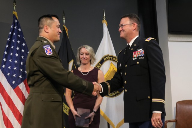 Lt. Col. Michael Flynn is administered the oath of office by DEVCOM AvMC Military Deputy Col. Steven Ansley, while wife Lisa looks on.