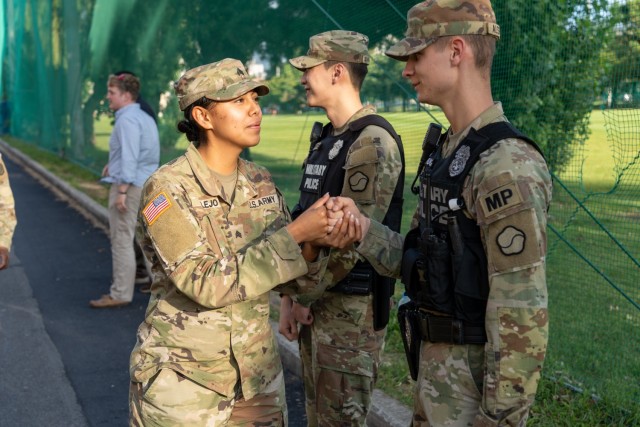 Sgt. Bertha Alejo congratulates Pfc. Dalton Alspaugh with a fist bump at Camp Walker, Republic of Korea, September 14, 2022. Alspaugh administered first aid to a Korean vehicle accident victim on September 13, 2022, providing emergency support assistance until Korean first responders could arrive.