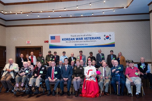 The Korean War veterans and others gather during the luncheon at The Summit. 