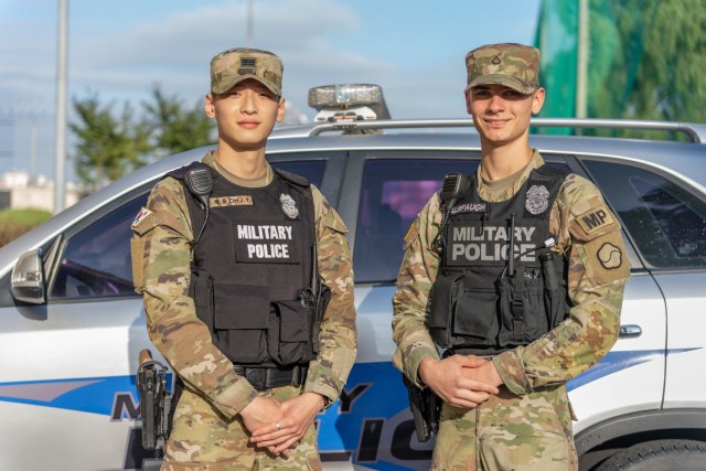 Cpl. Oh Jae Yoon and Pfc. Dalton Alspaugh pose in front of their vehicle at Camp Walker, Republic of Korea, September 14, 2022. On September 13, 2022, Oh and Alspaugh provided emergency support assistance to a traffic accident victim  until Korean first responders could arrive. 