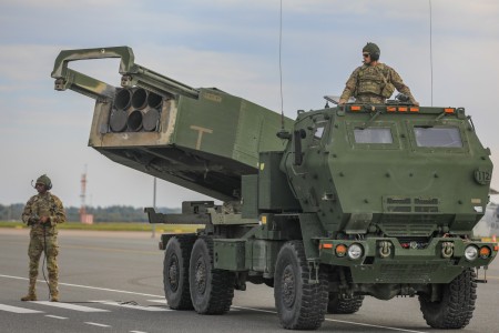 U.S. Army Spc. Jamil P. Samuel, left, and Pfc. Richard S. Gammon, both High Mobility Artillery Rocket System (HIMARS) crew members assigned to Baker Battery, 3rd Battalion, 321st Field Artillery Regiment (3-321 FAR), 18th Field Artillery Brigade prepare an M142 HIMARS during a Latvian-led field artillery live fire exercise, NAMEJS, at Liepāja, Latvia, Sept. 26, 2022.