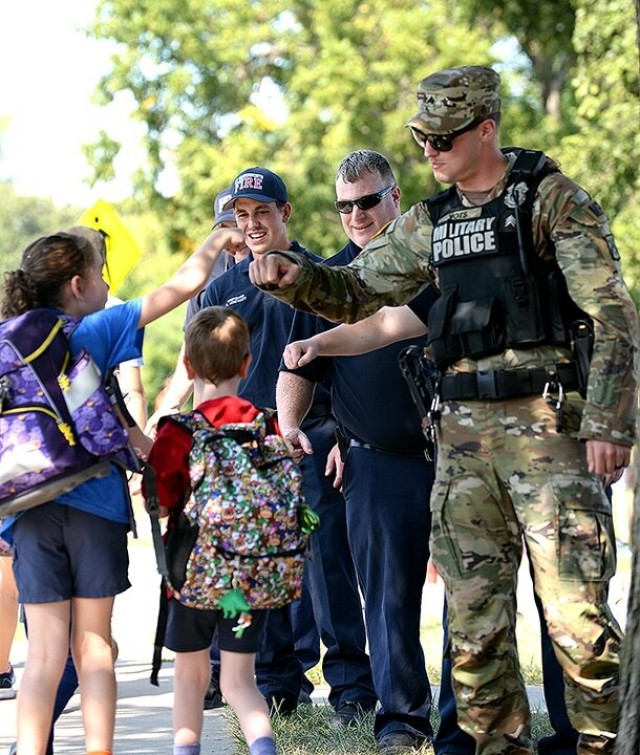 Fist Bump Fridays: Emergency responders greet students after school each month