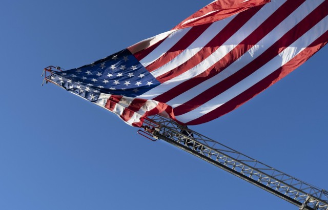 A gigantic U.S. flag billows in the wind after a Fort Jackson firefighter released it from a Fort Jackson Fire Department ladder truck Oct. 4 at Hilton Field. The flag was flown over the  post's National Night Out event.